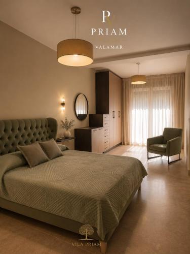 a bedroom with a large bed and a chair at Valamar Priam Villa D11 in Hamallë