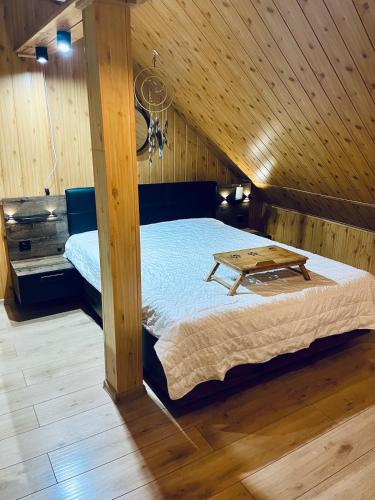 a bedroom with a bed with a table on it at Agro Bieszczady 2 in Czarna