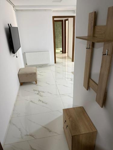 a living room with white walls and white marble floors at Lux appartement S plus deux a hay el wahat in El Aouina Station
