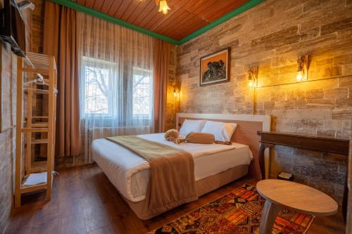 a bedroom with a bed with a teddy bear on it at Arton İn Cappadocia in Göreme