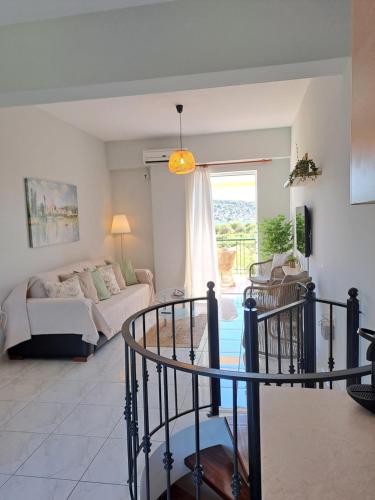 a living room with a couch and a table at Το Είδωλον Sea Maisonettes & Studio in Ancient Epidauros