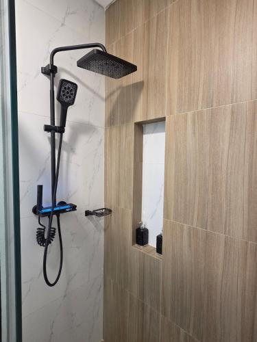 a shower with a shower head in a bathroom at Premium 21 Suites in La Paz