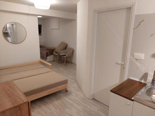 a small living room with a door and a table at Juraj apartman studio in Brdovec