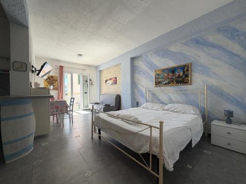 a bedroom with a bed and a painting on the wall at Al Baglio di Sant'Elia in Santa Flavia