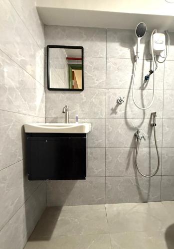 a bathroom with a sink and a shower at Hotel EcoStay at Chow kit in Kuala Lumpur
