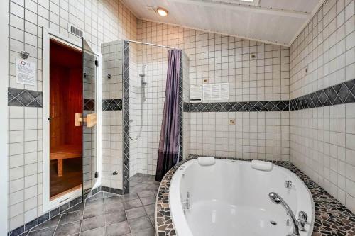 a bathroom with a tub and a walk in shower at C11761-Hemmet-Sydmarken-27 in Falen