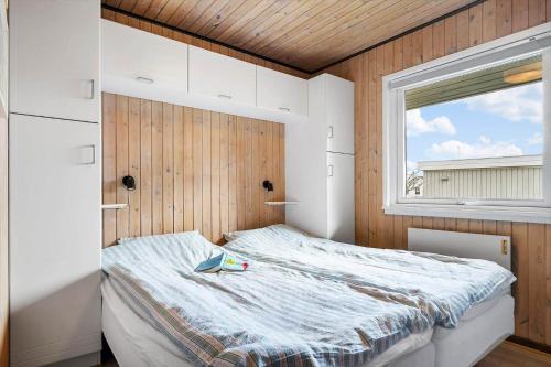 a small bedroom with a bed with a window at 40322-Juelsminde-Frede-Juels-vej-261 in Sønderby