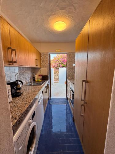 a kitchen with a sink and a dishwasher at Villa Valentina-Sunny 2 Bedroom House with Pool in Carvoeiro