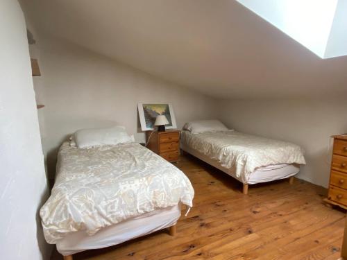 a bedroom with two beds and a dresser at Gîte de la Garriguette in Rasteau