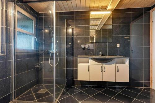 a bathroom with a sink and a shower at C11769-Hemmet-Vester-Faelled-14 in Falen