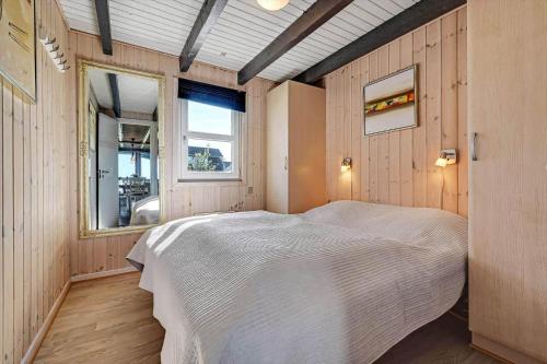 a bedroom with a bed and a window in it at C11769-Hemmet-Vester-Faelled-14 in Falen