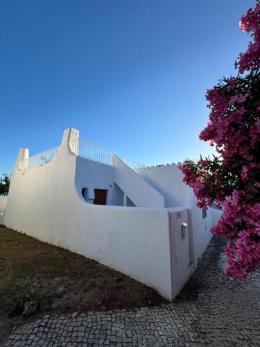 a white building with a staircase on the side of it at Villa Valentina-Sunny 2 Bedroom House with Pool in Carvoeiro