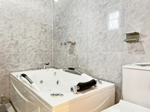 a bathroom with a sink and a toilet at Domina Apartment in Kubwa