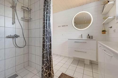 a white bathroom with a shower and a sink at C11768-Hemmet-Klydevaenget-4 in Falen