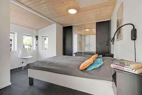 a bedroom with a bed and a desk in it at C11768-Hemmet-Klydevaenget-4 in Falen