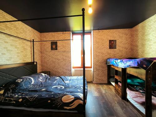 a bedroom with two bunk beds and a window at La Chambres des Secrets in Vierzon