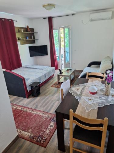 a living room with a bed and a table and chairs at Samardzici in Risan