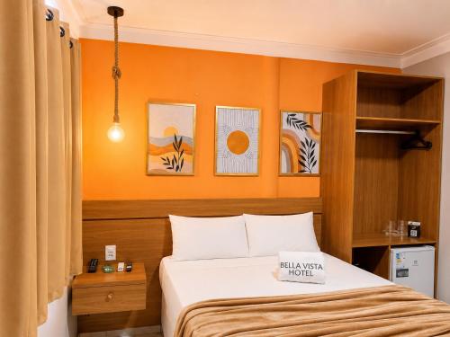 a bedroom with a bed and some pictures on the wall at Bella Vista Hotel in Barreirinhas