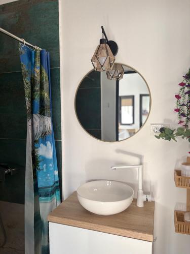 a bathroom with a sink and a mirror at SUN Bungalow Costinești in Schitul