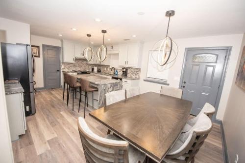 a kitchen with a wooden table and a dining room at Spacious Dawsonville 4 bedrooms with 8 beds Sleeps 10 for Work crews and Large groups of friends and families in Dawsonville
