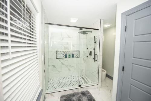 a walk in shower in a bathroom with a glass door at Spacious Dawsonville 4 bedrooms with 8 beds Sleeps 10 for Work crews and Large groups of friends and families in Dawsonville