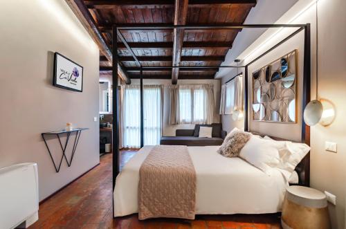 a bedroom with a bed and a living room at Villa Ca' Viola Rimini in Rimini