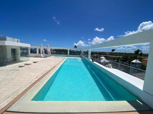 a swimming pool on the roof of a house at AVENTURA SUITES playa LOS CORALES - great location! in Punta Cana