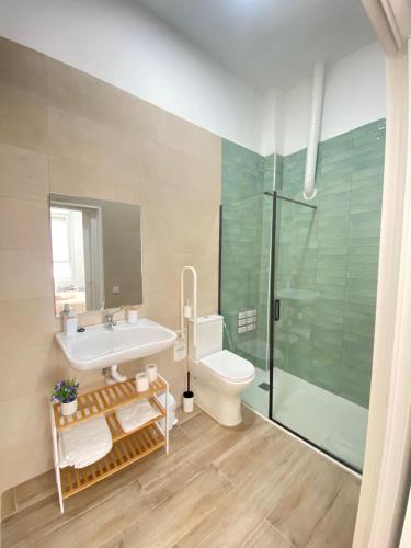 a bathroom with a sink and a toilet and a shower at Grampy Boutique Hostal - Zaragoza Centro in Zaragoza