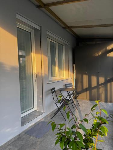 a patio with two chairs and a table next to a building at Seicuori Padova - 2 Camere, 2 Bagni, Parcheggio in Padova