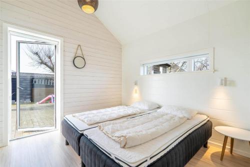 a large bed in a room with a window at 173-Ringkobing-Sondervig-Landevej-29 in Søndervig