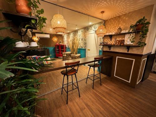 a kitchen with a bar and stools in a room at Vivaz Boutique Hotel in Recife