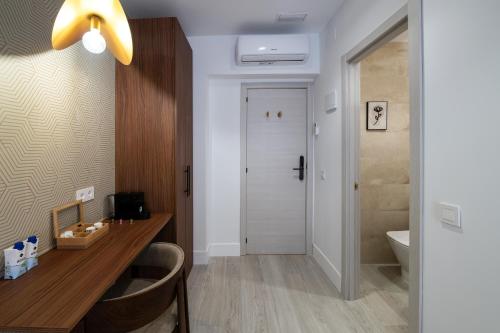 a bathroom with a vanity and a toilet and a sink at Rosales Suites in Madrid