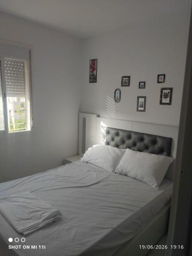 a white bedroom with a large bed with white sheets at Isco Stam in Martil