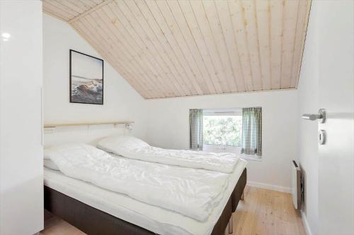 a bedroom with two beds and a coffered ceiling at FY132-Middelfart-Stjernevej-109 in Middelfart
