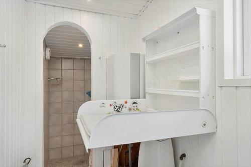 a white bathroom with a sink and a shower at 1105-ringkobing-Fyrrealle-20 in Nørby