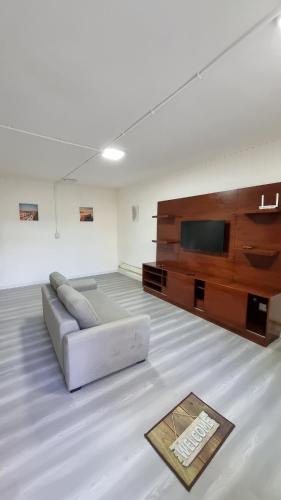 a living room with a couch and a flat screen tv at Hermosos monoambientes a estrenar in Comodoro Rivadavia