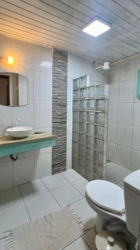 a bathroom with a toilet and a sink and a shower at Wind & Sun Kite Pousada in Canoa Quebrada
