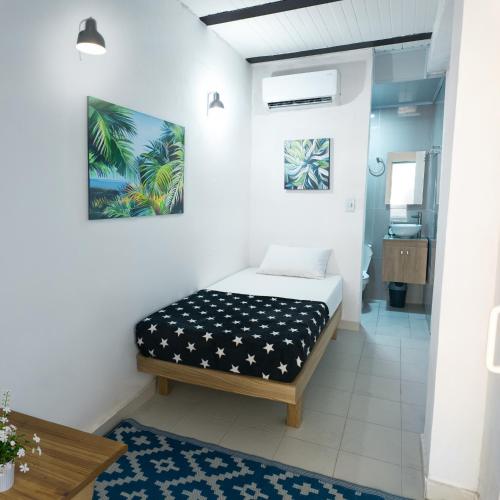 a bedroom with a bed in a room at Casa Daguer Beach House in Cartagena de Indias