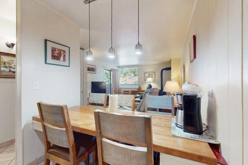 a kitchen and dining room with a wooden table and chairs at Second-floor condo with 2 shared pools hot tub sauna in South Lake Tahoe