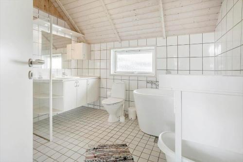 a bathroom with a tub and a toilet and a sink at FY244-Assens-Osterbakken-3 in Assens