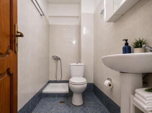 a bathroom with a toilet and a sink at Gallery in Ammouliani