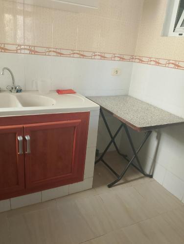 a kitchen with a sink and a counter top at Morgan Appartements in Hammam Sousse
