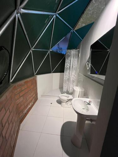 a bathroom with a sink and a toilet at Sky Domos Pachar in Pachar