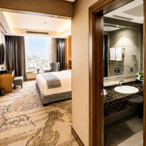 a hotel room with a bed and a bathroom at Medhal Hotel in Jeddah
