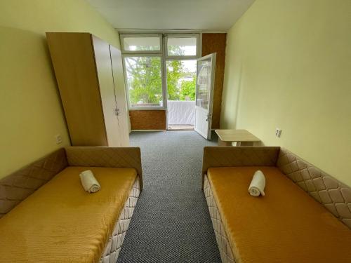 a waiting room with two couches and a window at MiegOK777 in Palanga