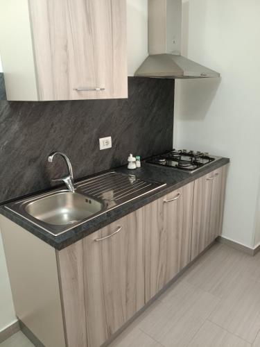 a kitchen with a sink and a stove at Affittacamere La Casa Dei Nonni in Polizzi Generosa