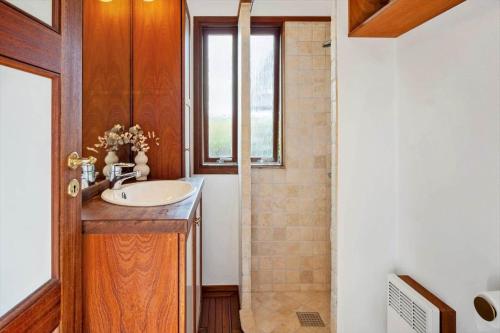 a bathroom with a sink and a window at FY267-Faaborg-Horsehoved-37 in Faaborg
