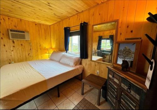 a bedroom with a bed in a wooden room at Lake Stop Resort in Buffalo