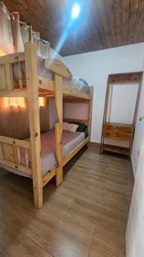 a bedroom with two bunk beds in a room at Hospedaje J & L in Uspallata