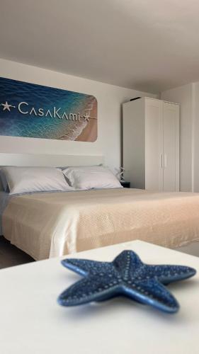 a blue starfish sitting on top of a bed at CasaKami Sky Terrace in Nettuno